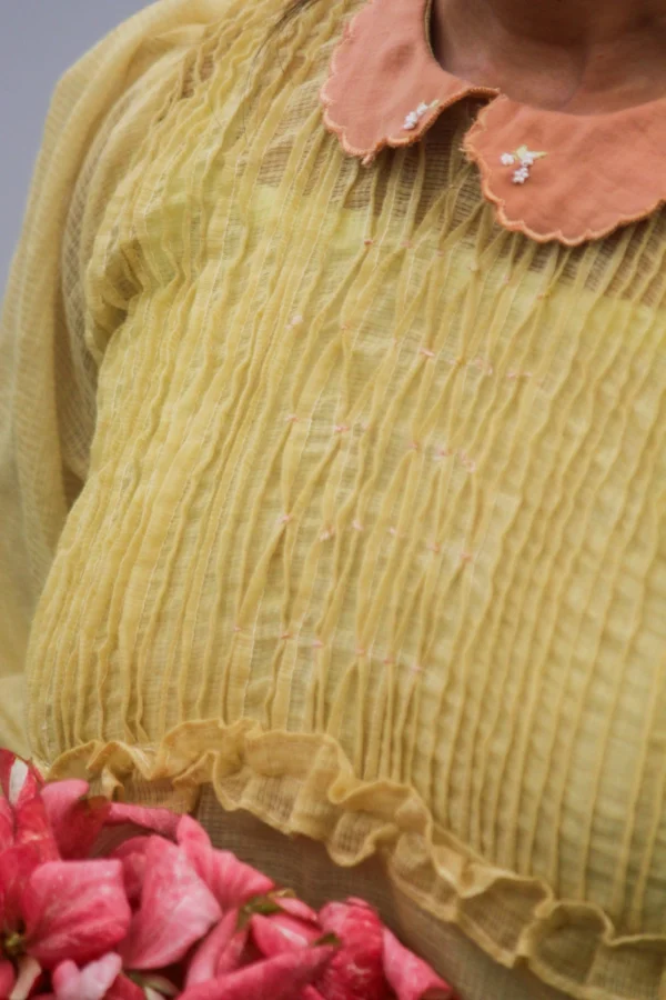 Naturally dyed golden yellow Kota dress with madder peach collar and floral embroidery